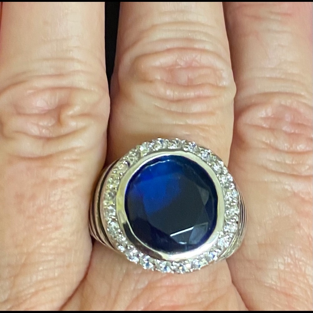 sterling silver ring with blue center stone and CZ